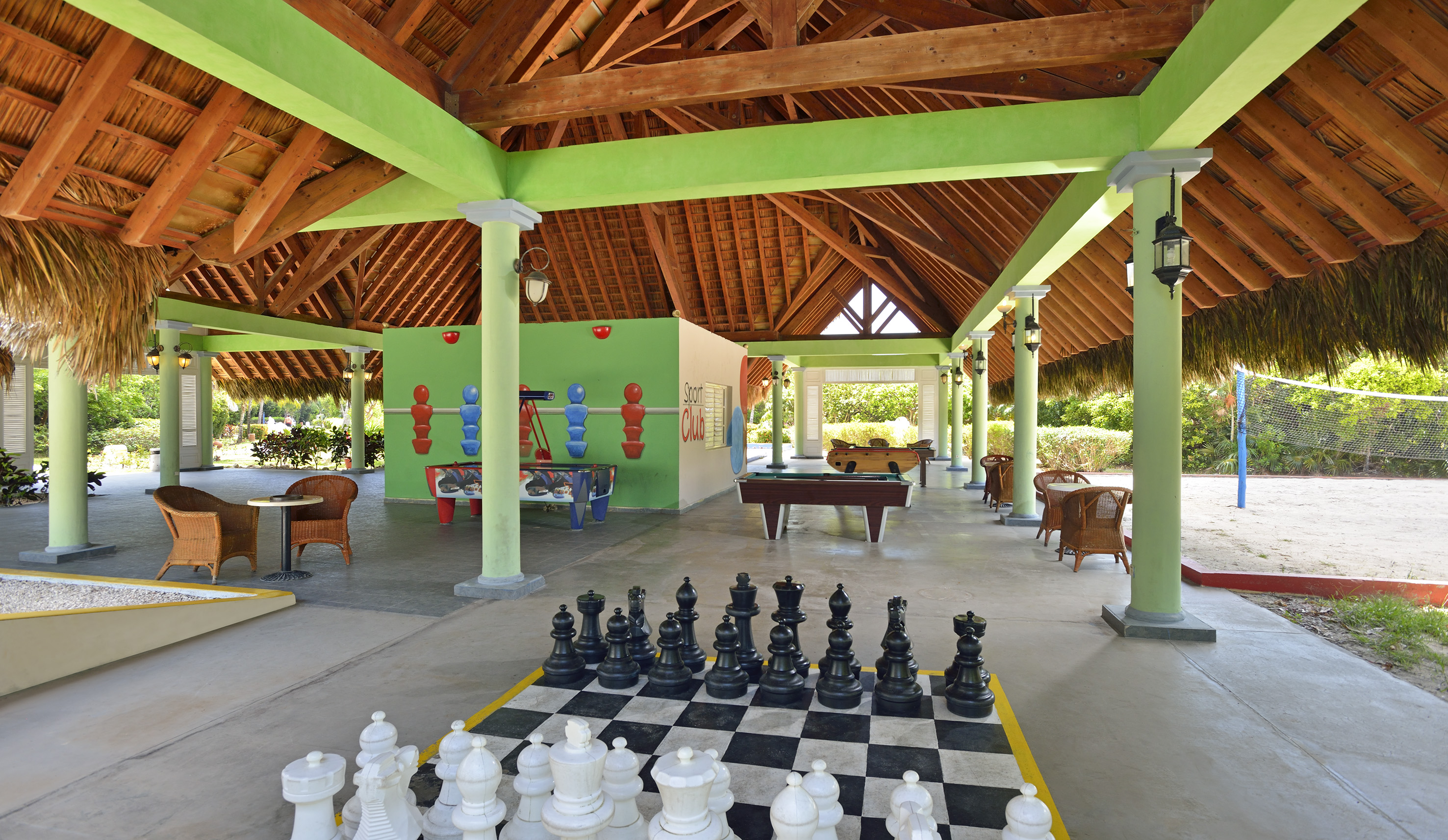 a large chess board in a room with tables and pool tables