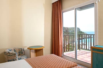 a room with a bed and a glass door