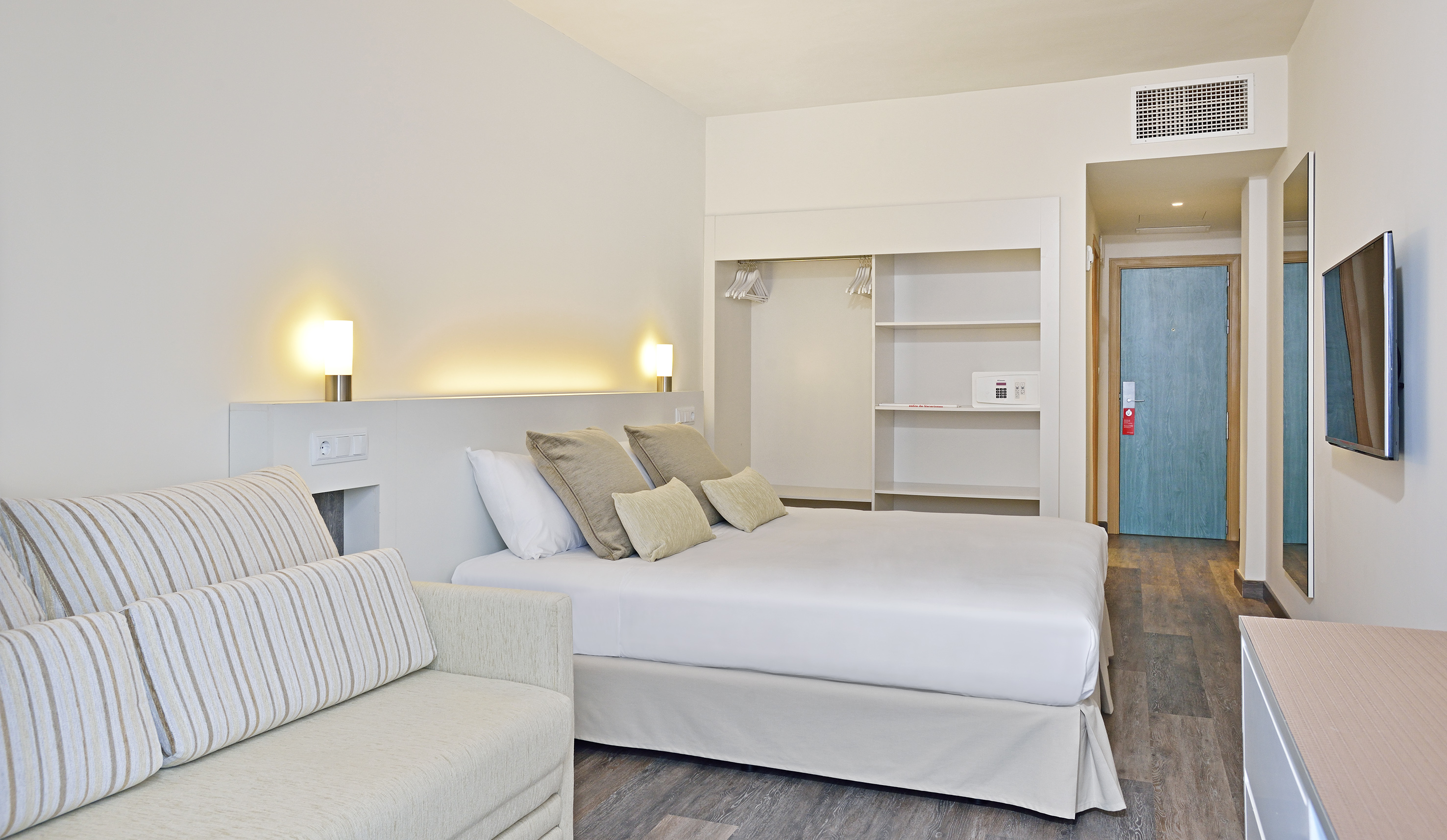 a bedroom with a bed and a couch