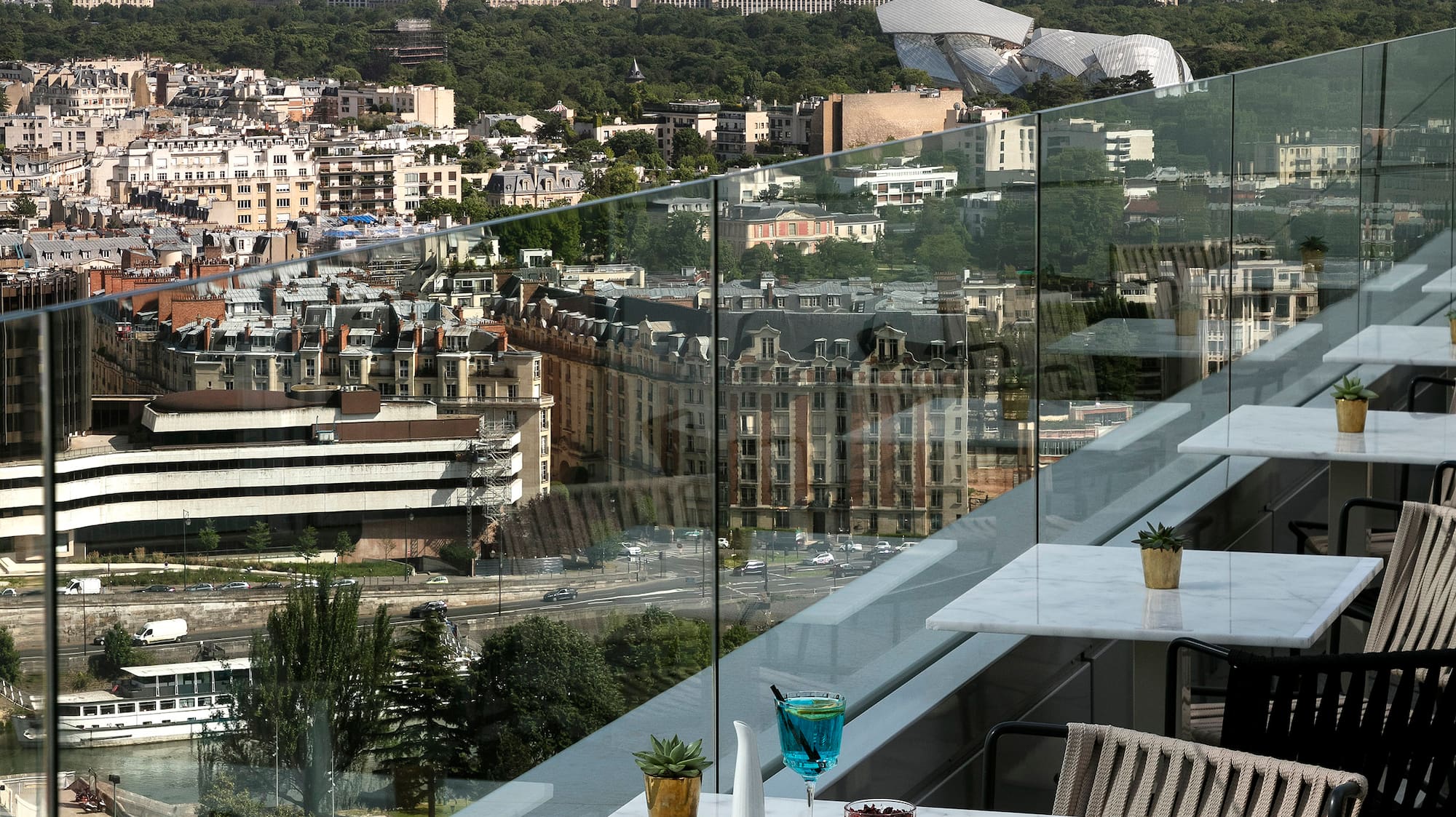 a table and chairs on a balcony overlooking a city