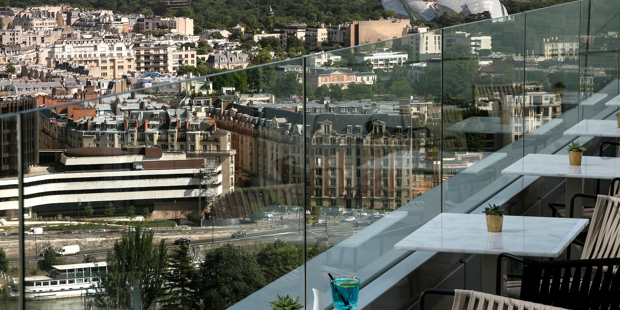 a table and chairs on a balcony overlooking a city