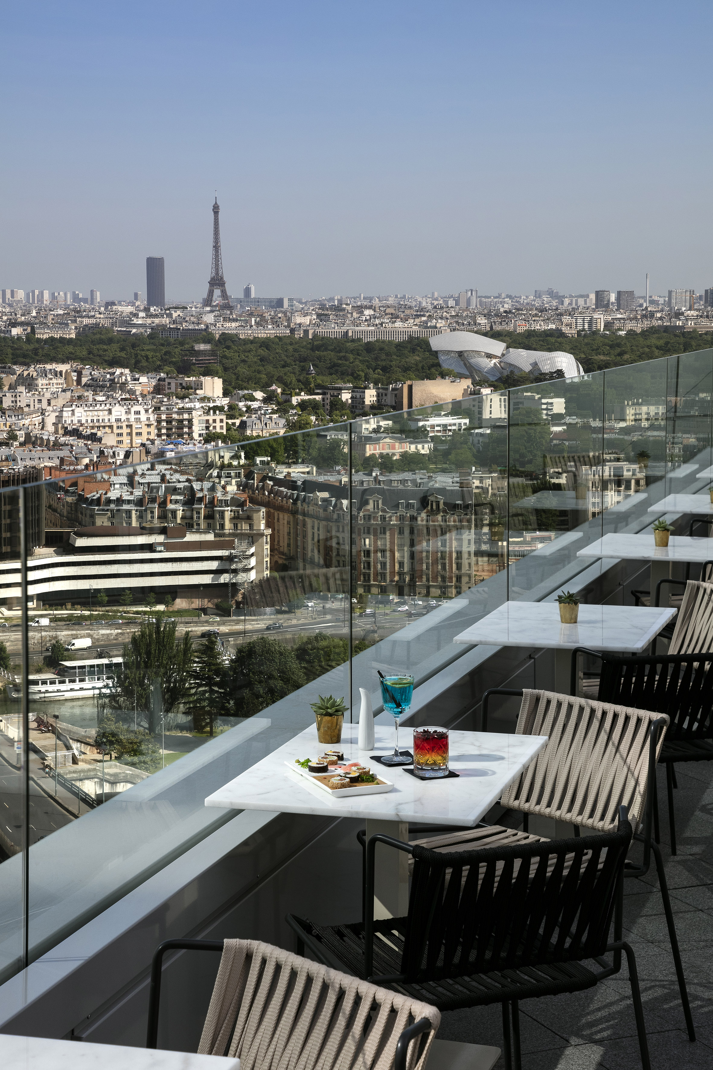 a table and chairs on a balcony overlooking a city