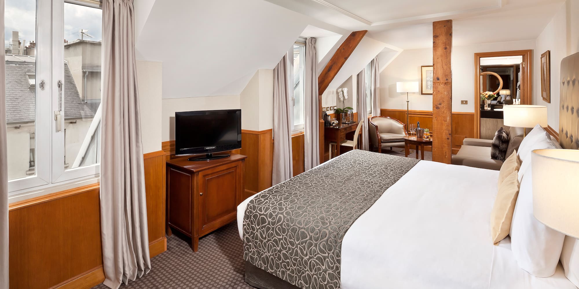 a bedroom with a bed and a television