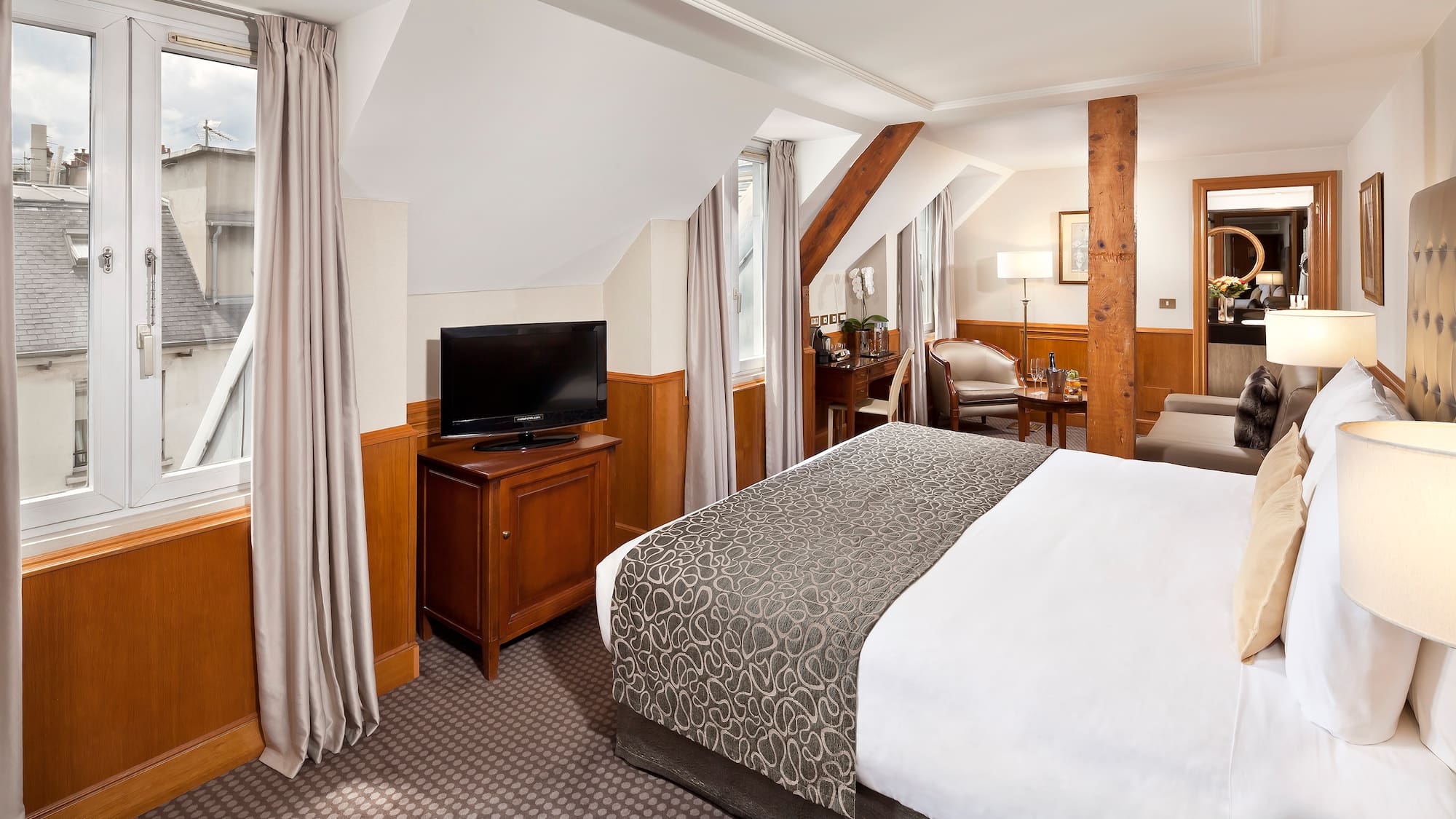 a bedroom with a bed and a television