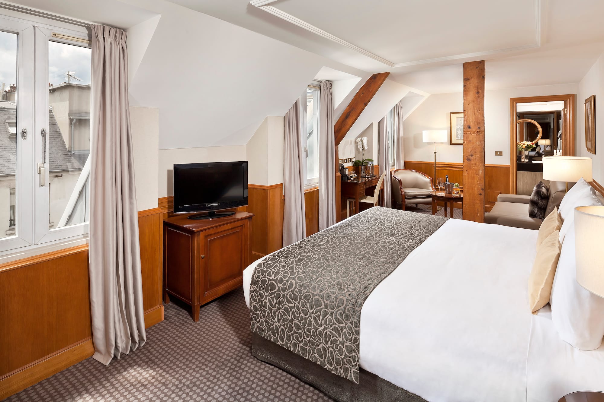 a bedroom with a bed and a television