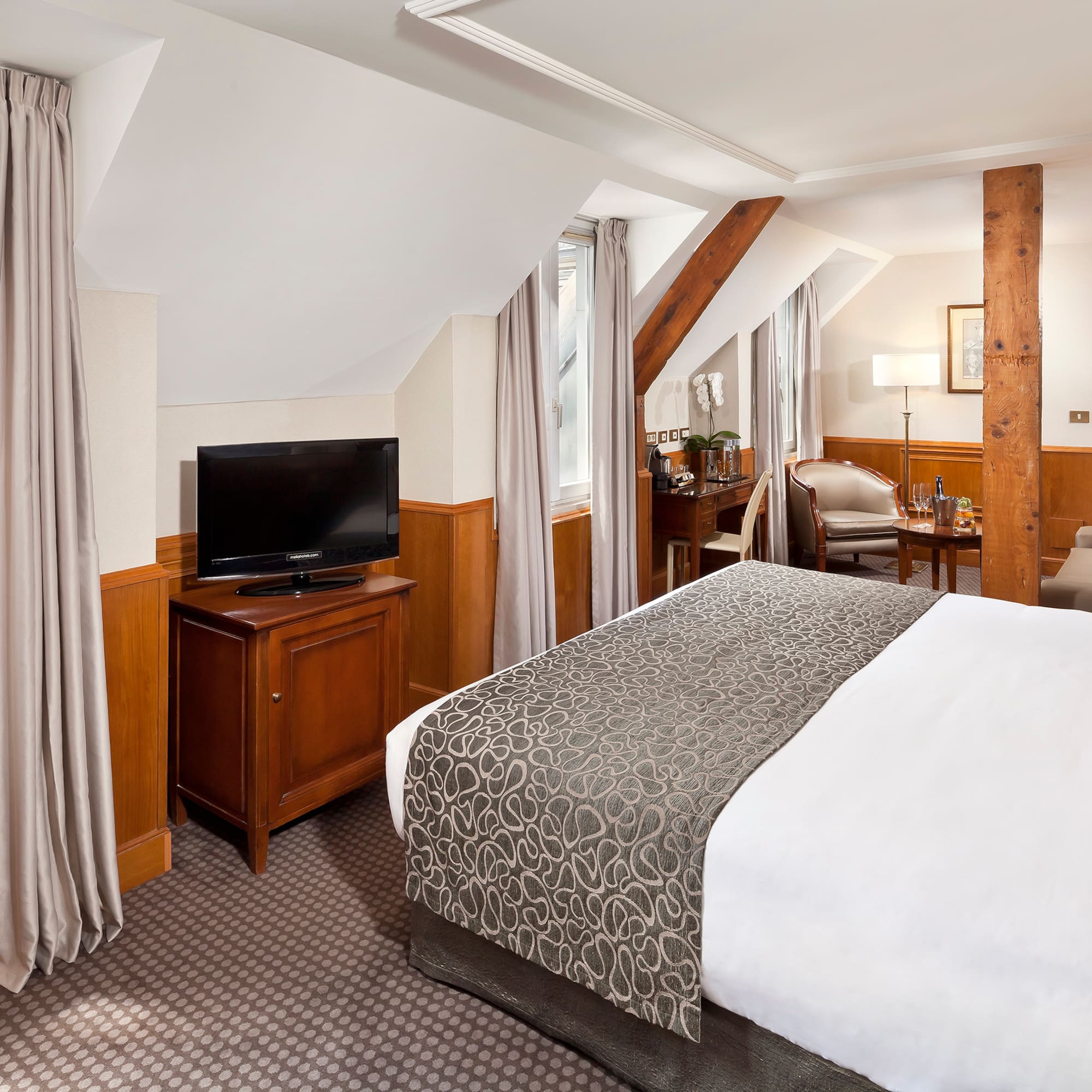 a bedroom with a bed and a television