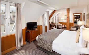 a bedroom with a bed and a television