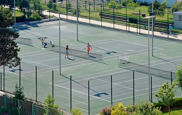 a group of people playing tennis