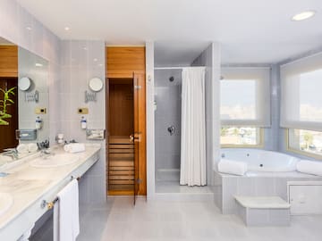 a bathroom with a bathtub and a tub