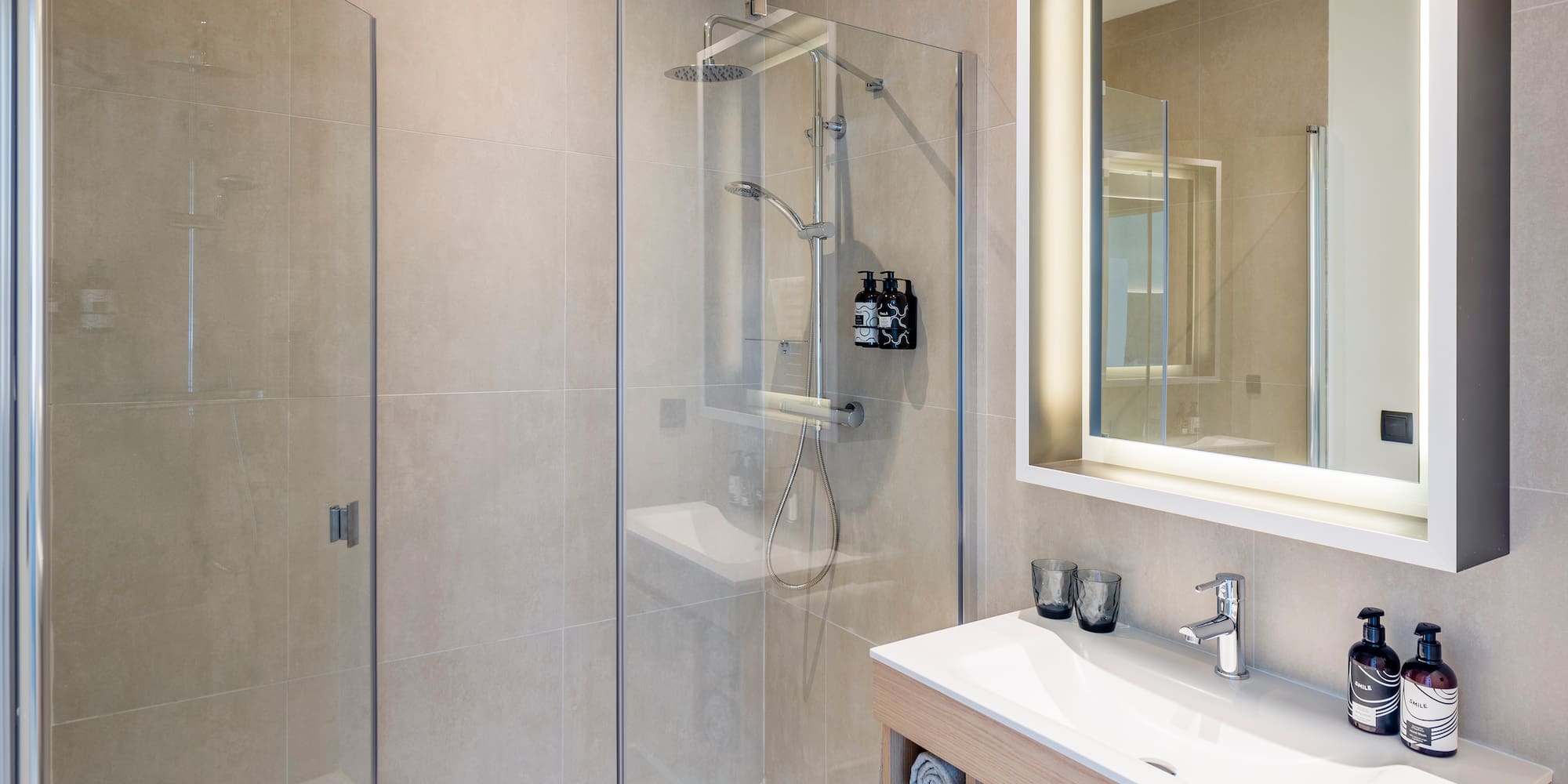 a bathroom with a glass shower and sink