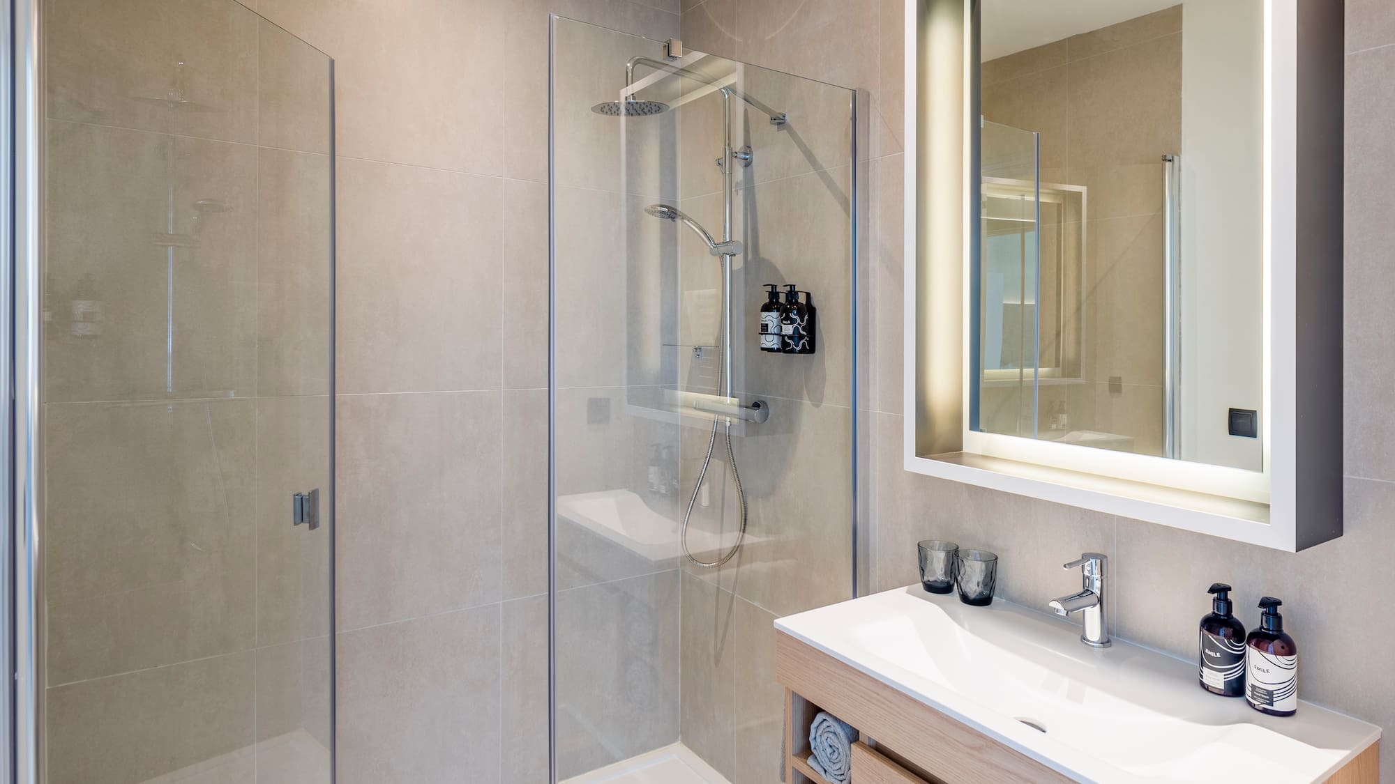 a bathroom with a glass shower and sink