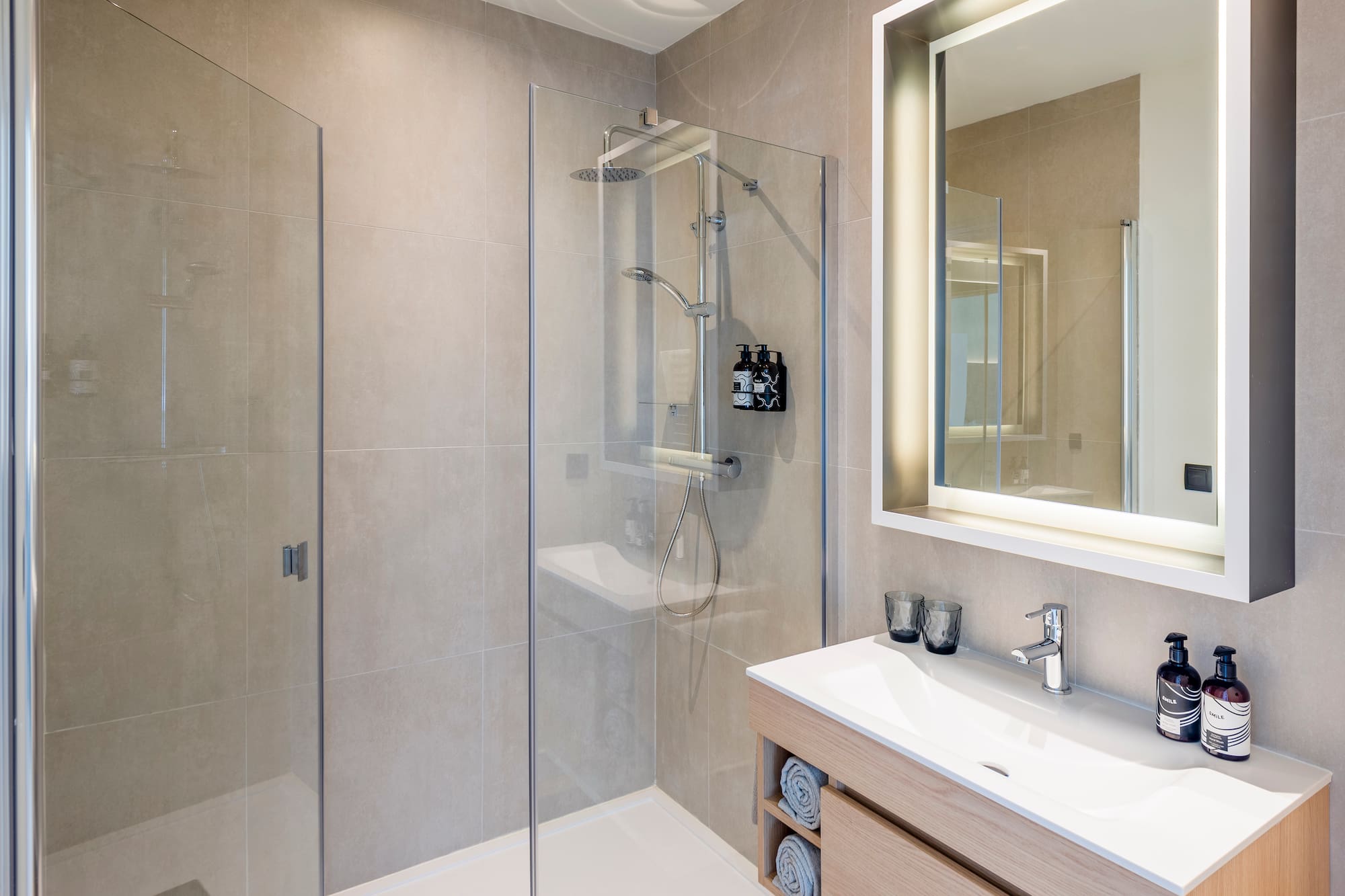 a bathroom with a glass shower and sink