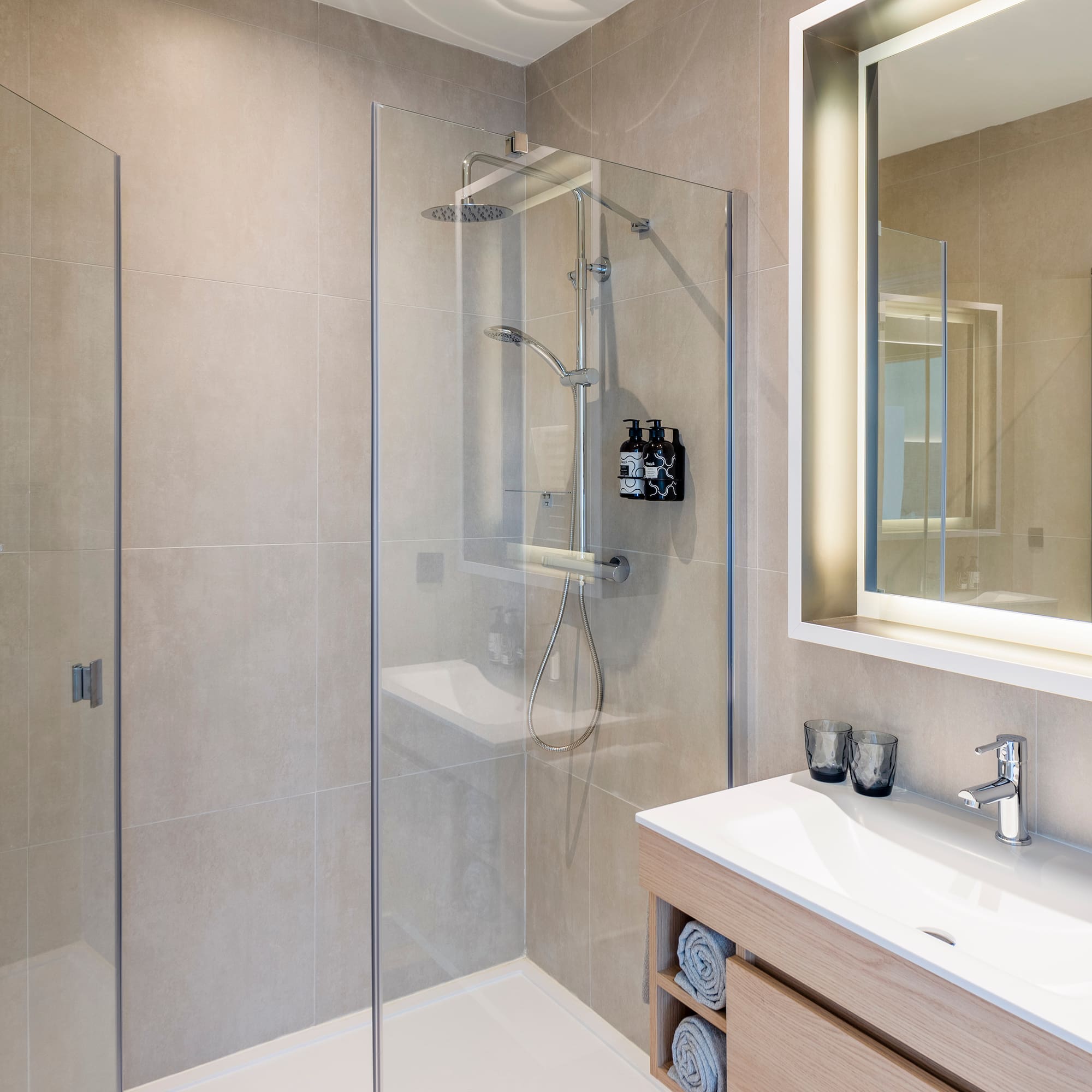 a bathroom with a glass shower and sink