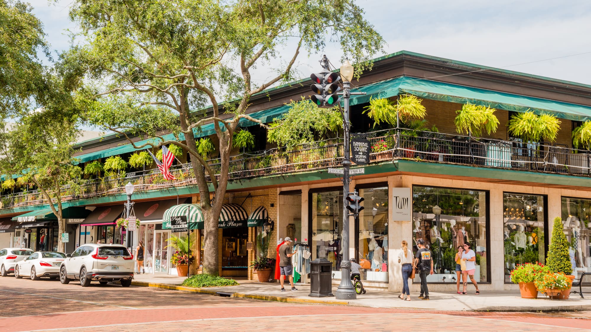 a building with trees and people on the street