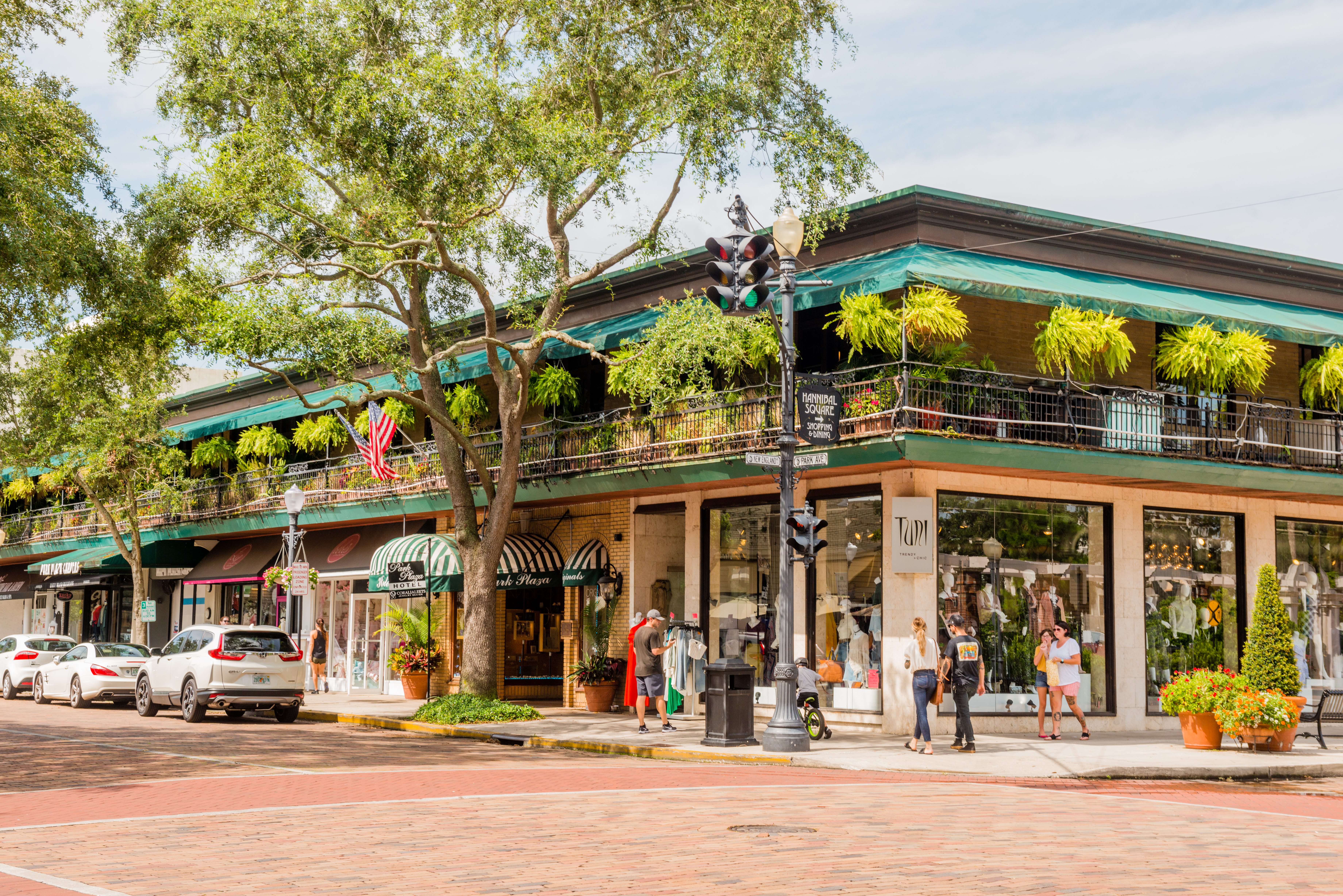 a building with trees and people on the street