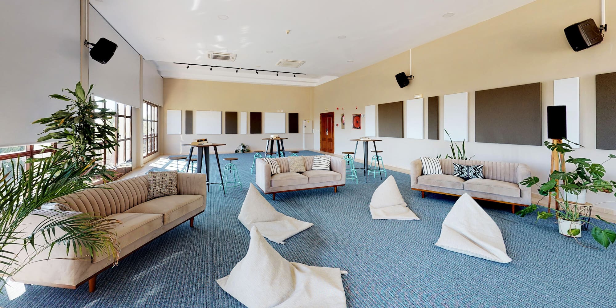 a room with a group of couches and tables