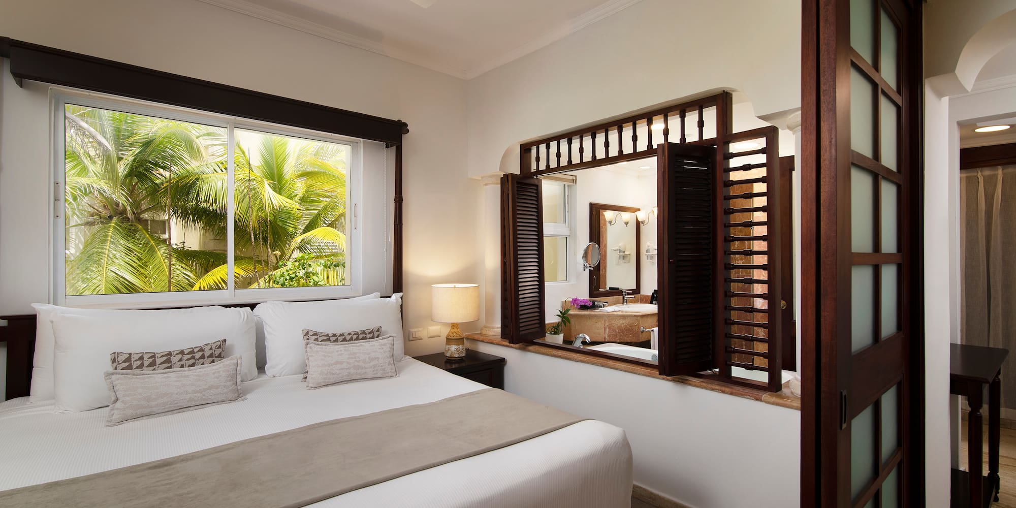 a bedroom with a window and a bed