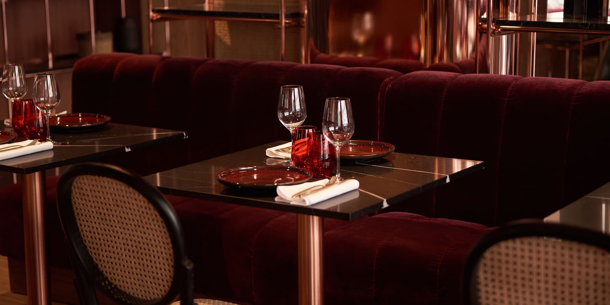 a table with wine glasses and plates on it