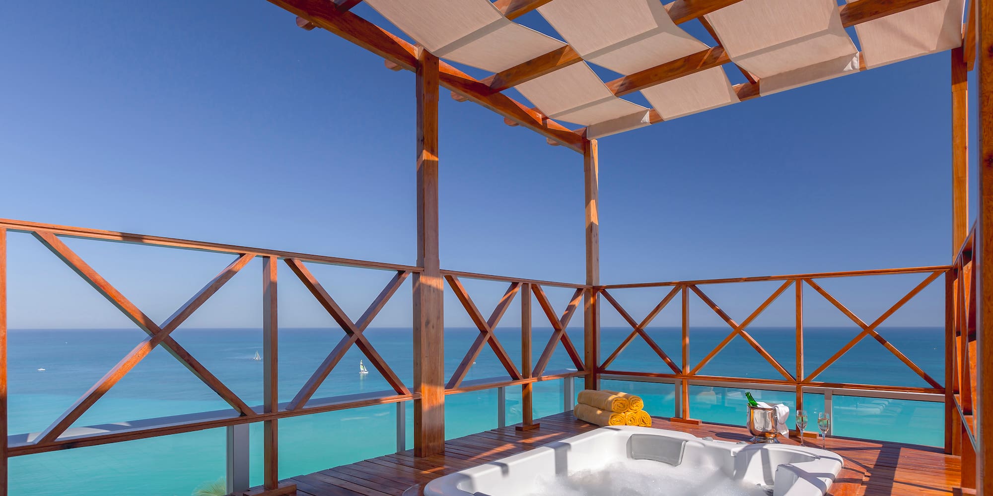 a hot tub on a deck overlooking the ocean