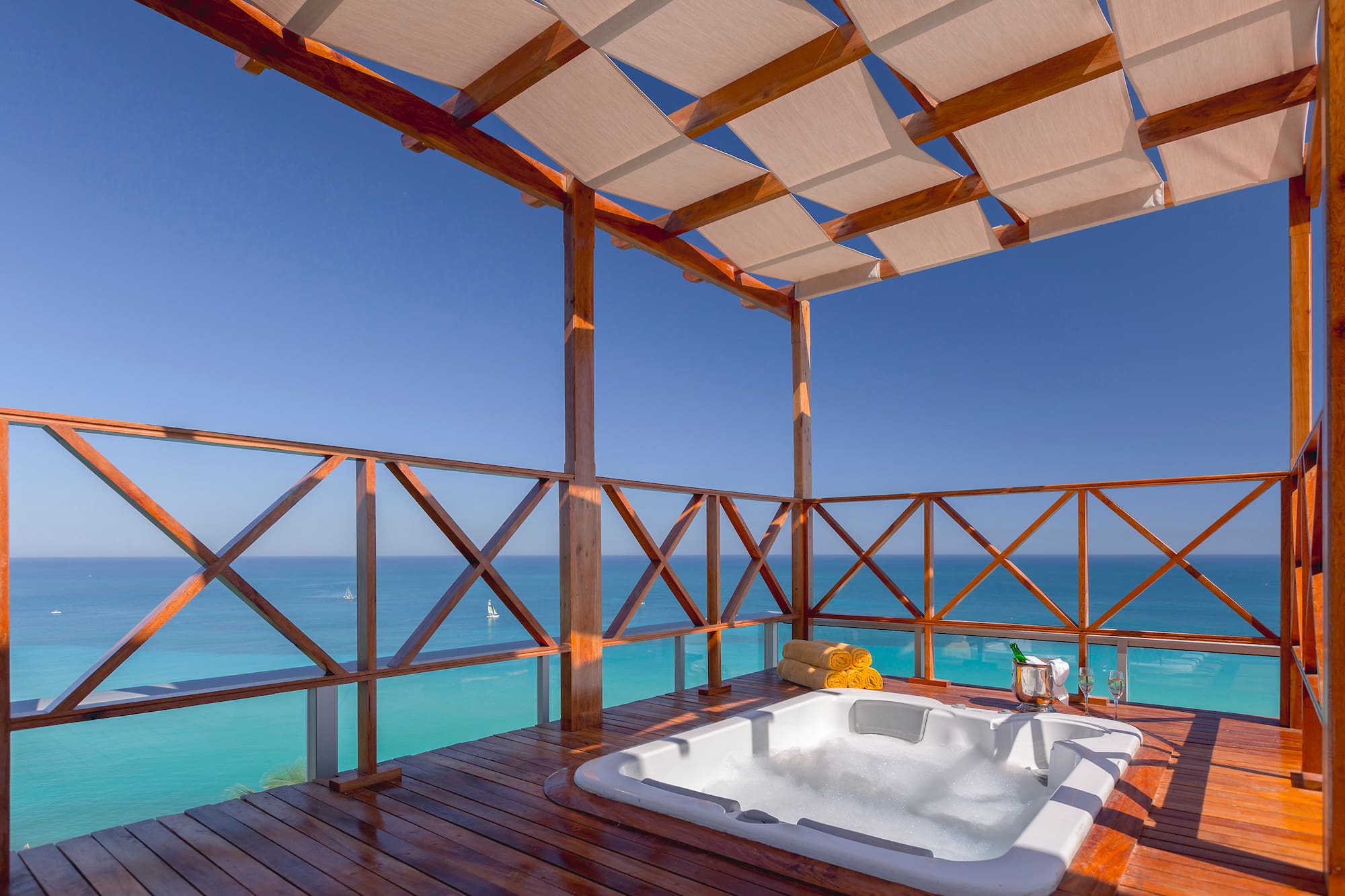 a hot tub on a deck overlooking the ocean