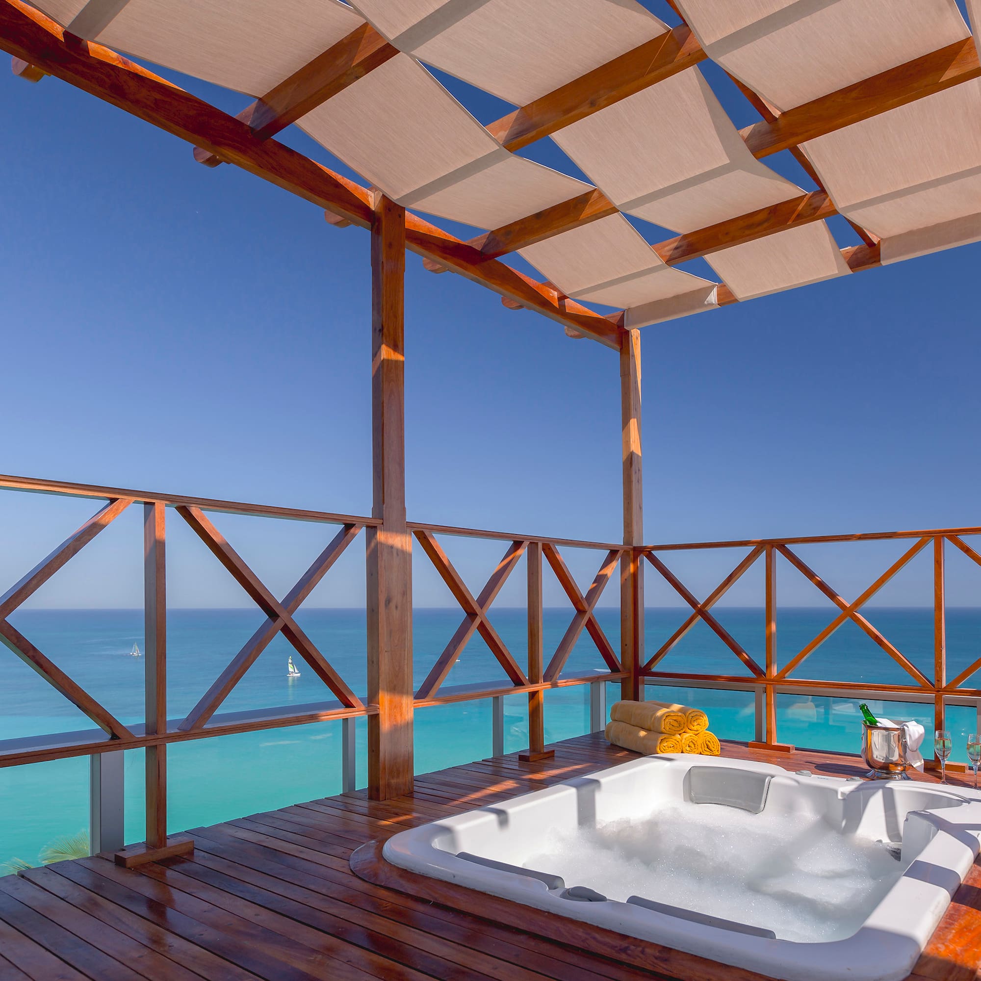 a hot tub on a deck overlooking the ocean