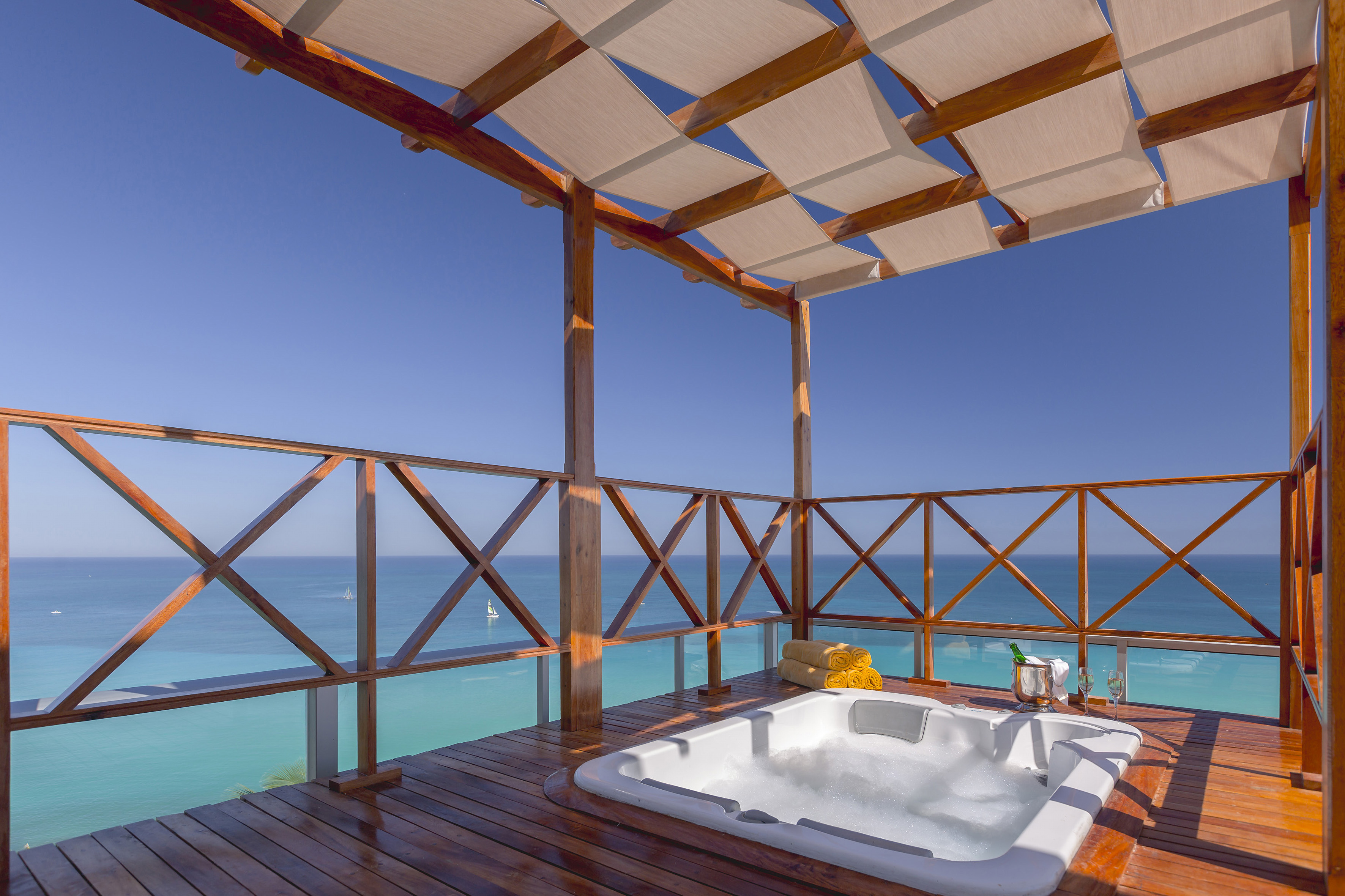 a hot tub on a deck overlooking the ocean