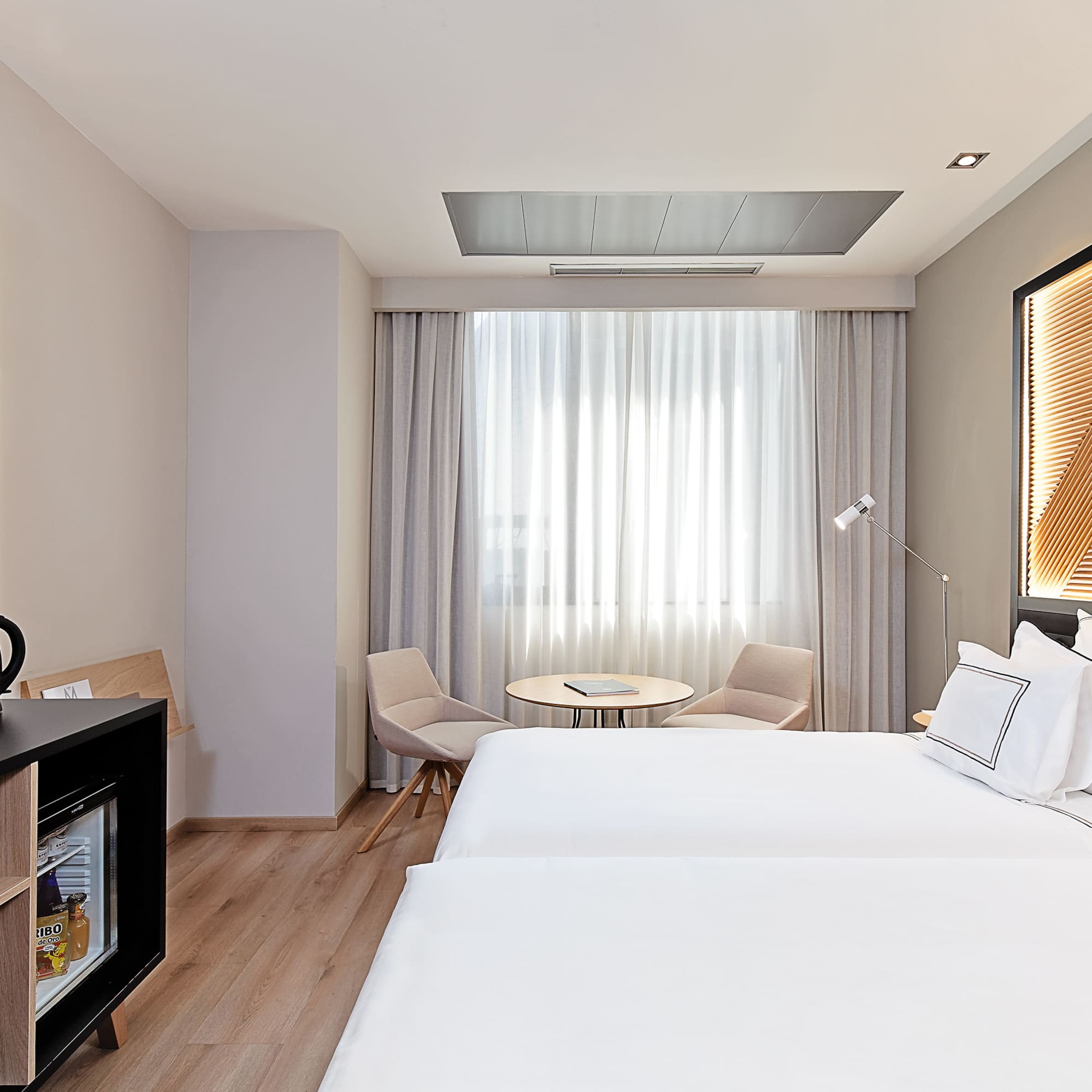 a room with two beds and a table