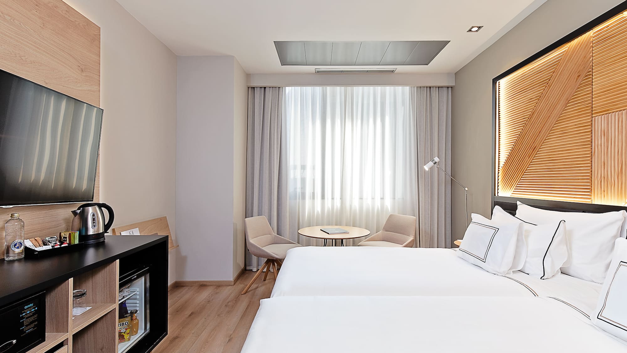 a room with two beds and a table