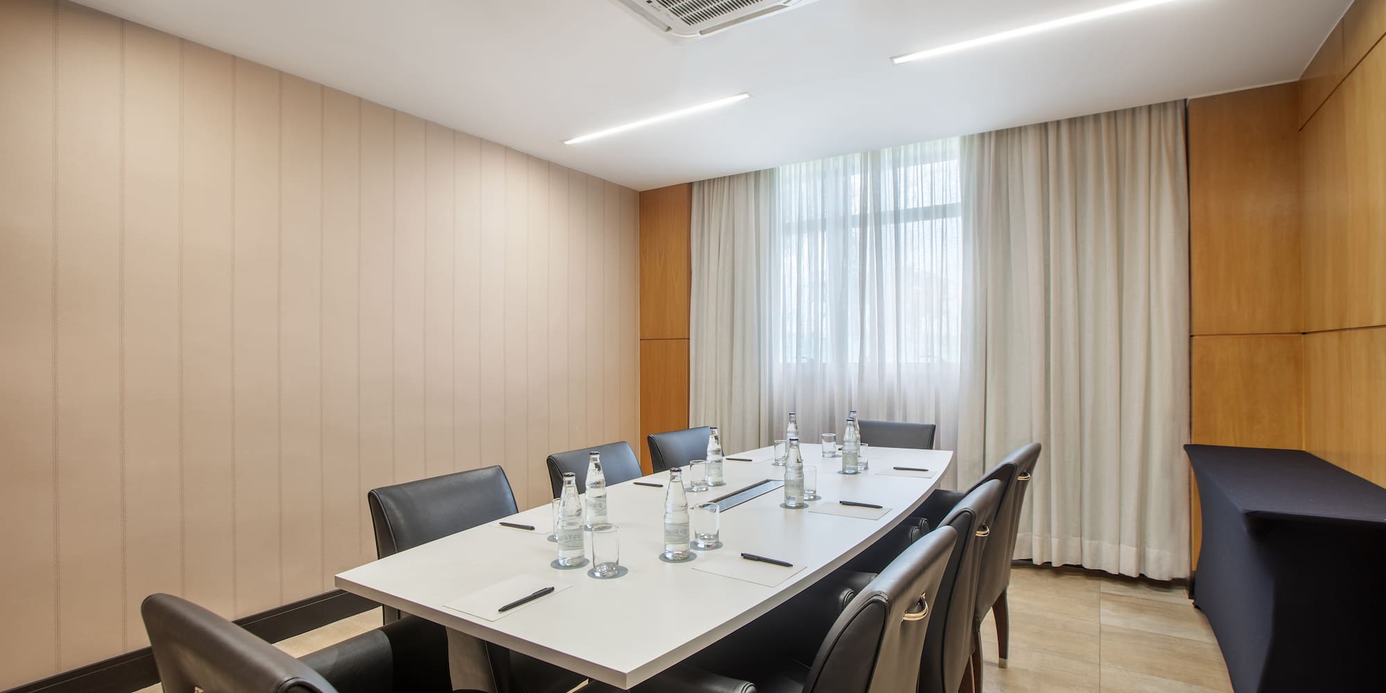 a conference room with a table and chairs