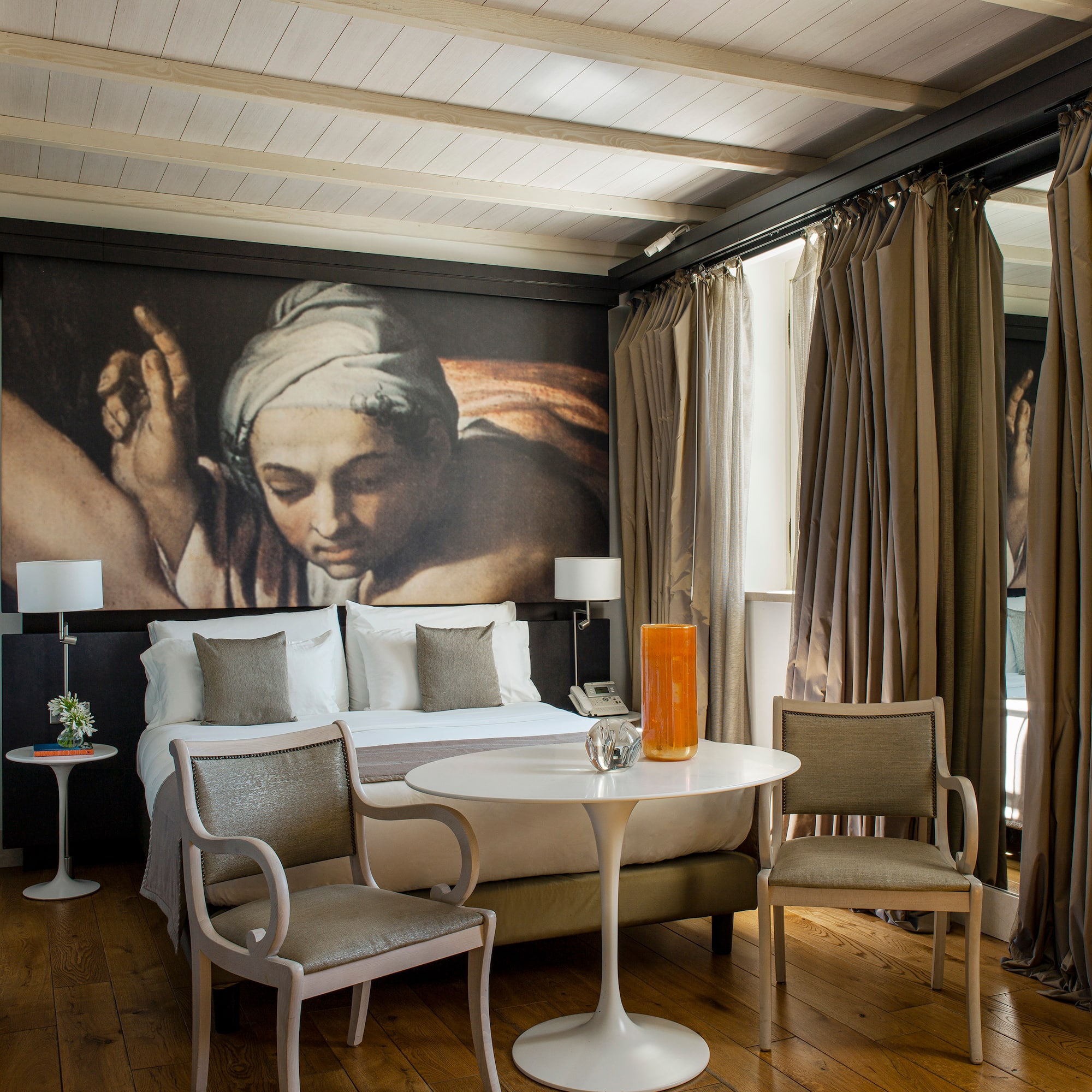 a room with a bed and chairs