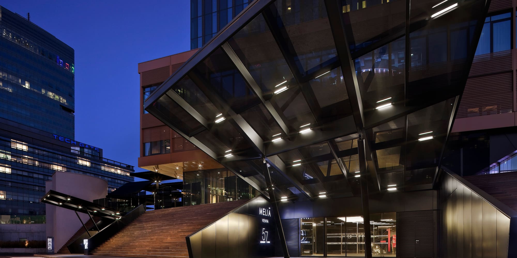 a building with glass walls and stairs