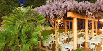 a covered patio with tables and chairs