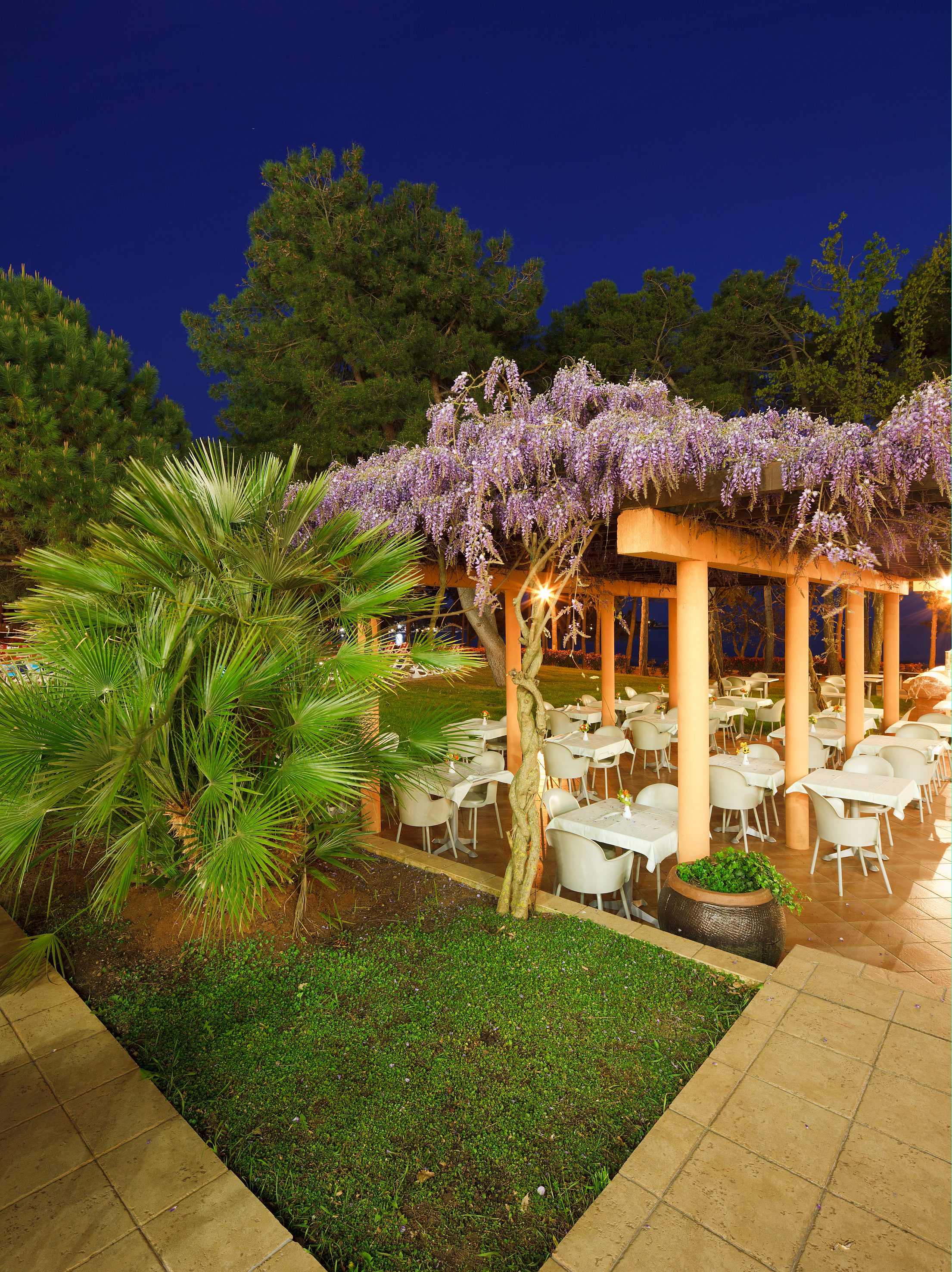 a covered patio with tables and chairs