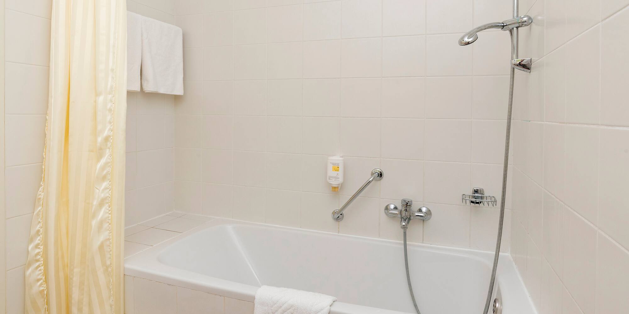 a bathtub and shower in a bathroom