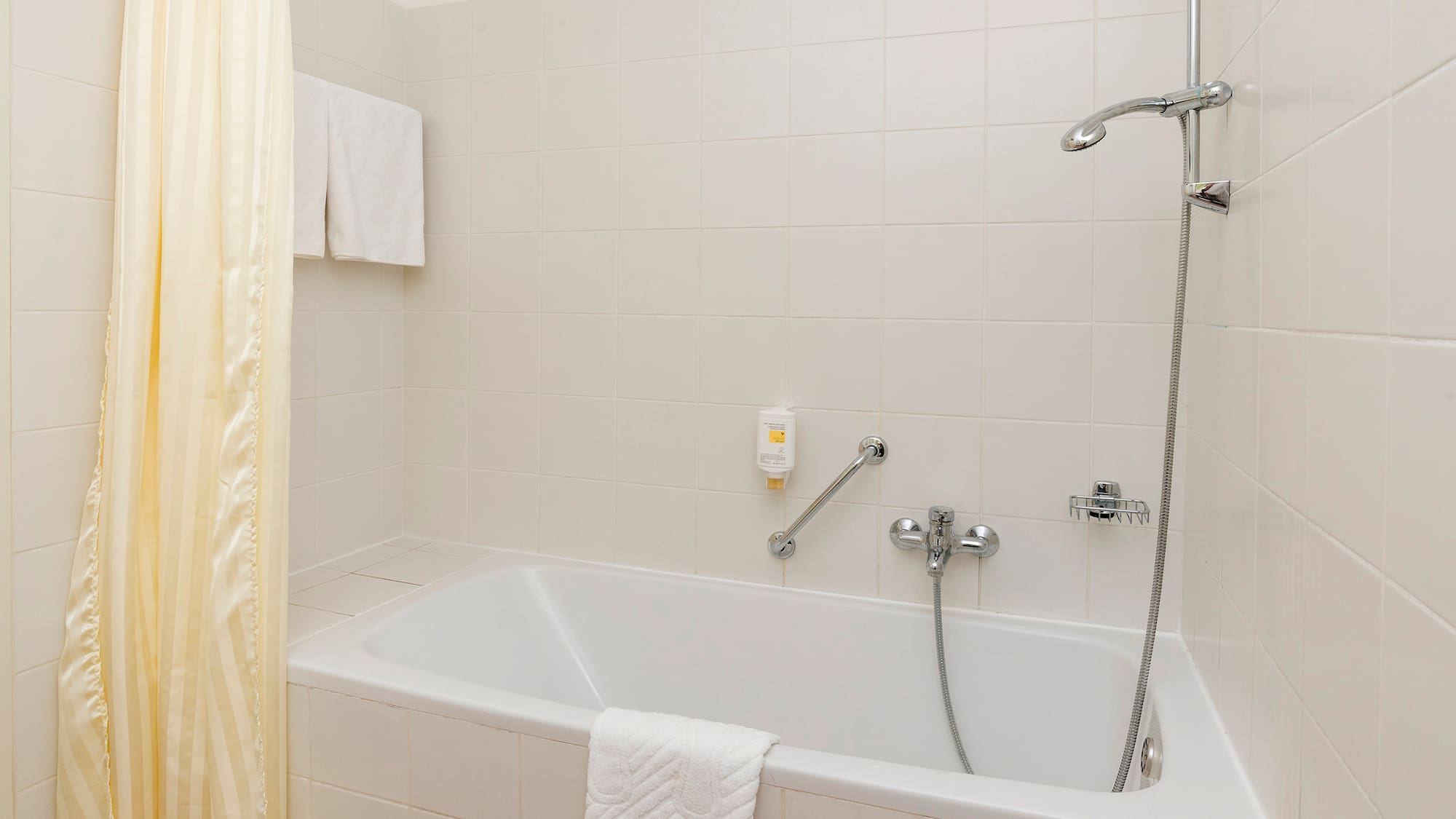 a bathtub and shower in a bathroom