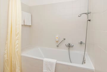 a bathtub and shower in a bathroom