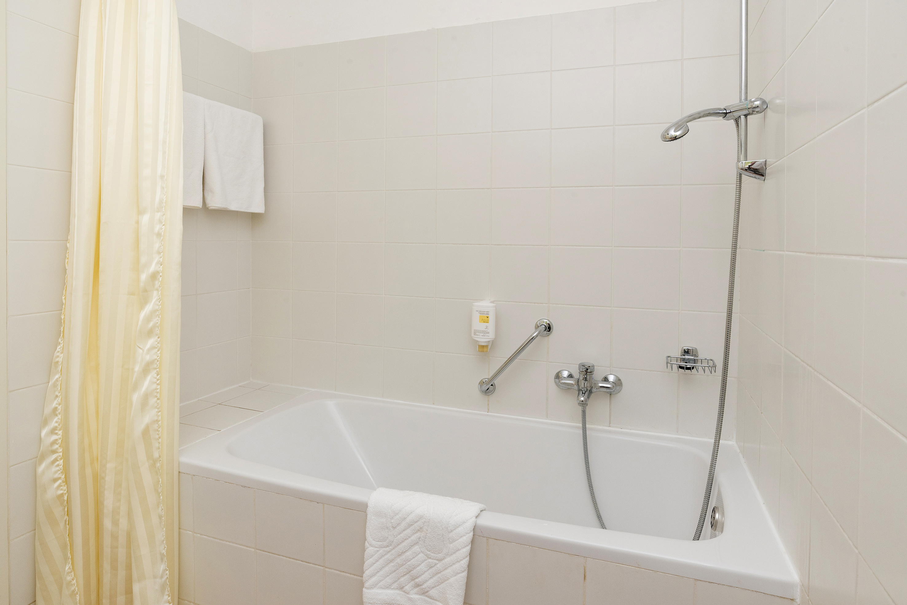 a bathtub and shower in a bathroom