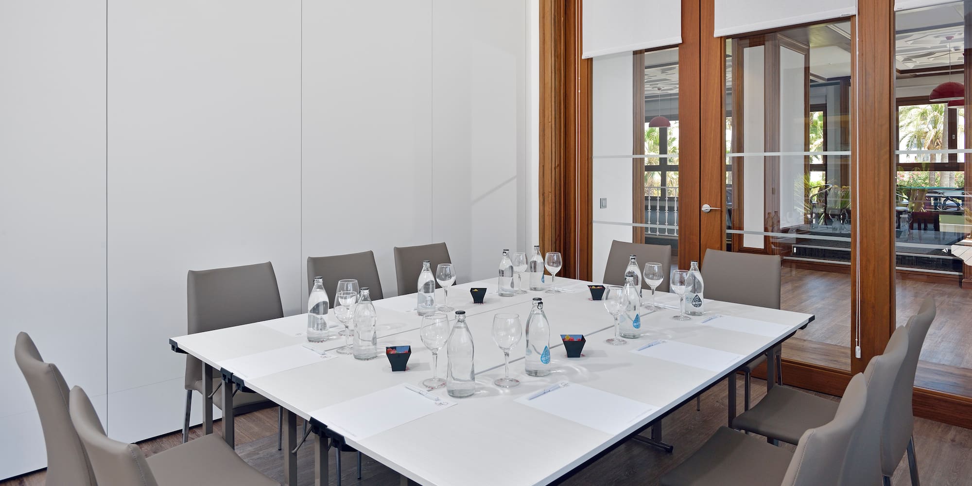 a table with empty glasses and water bottles on it