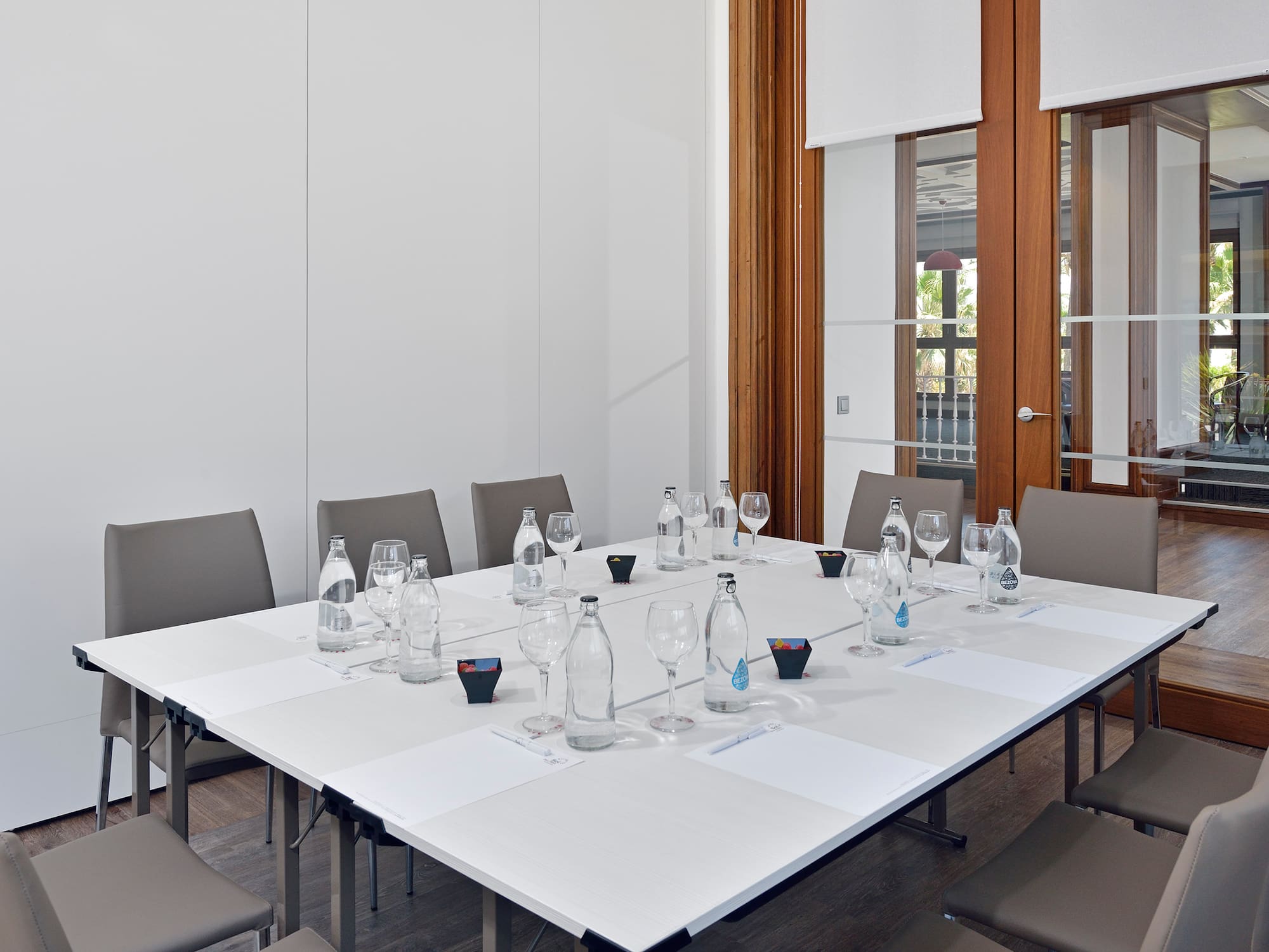 a table with empty glasses and water bottles on it