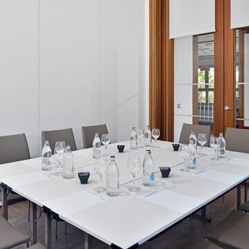 a table with empty glasses and water bottles on it