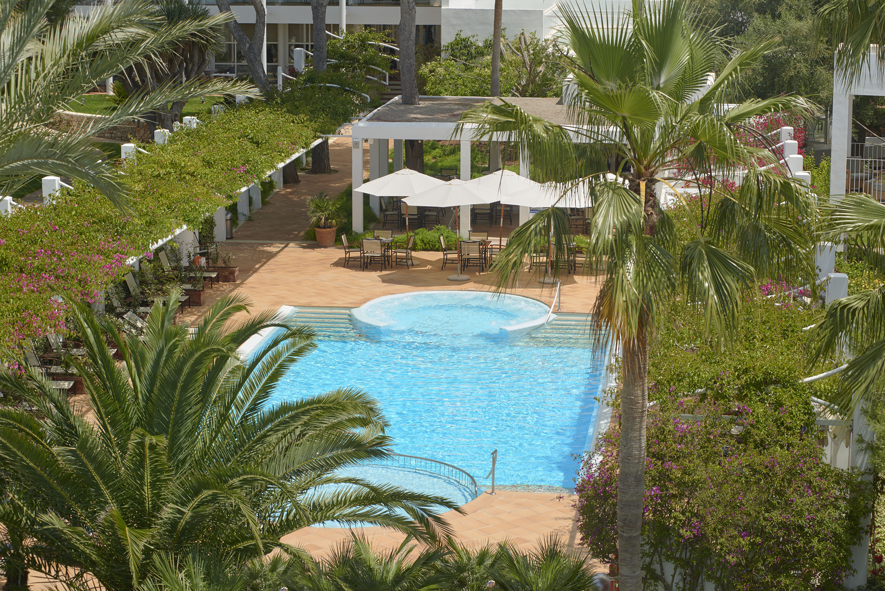 Hotel pool with jacuzzi, palm trees, and outdoor dining patio. - Piscine paesaggistiche sorprendenti - Meliá Cala d'Or Boutique Hotel, Maiorca