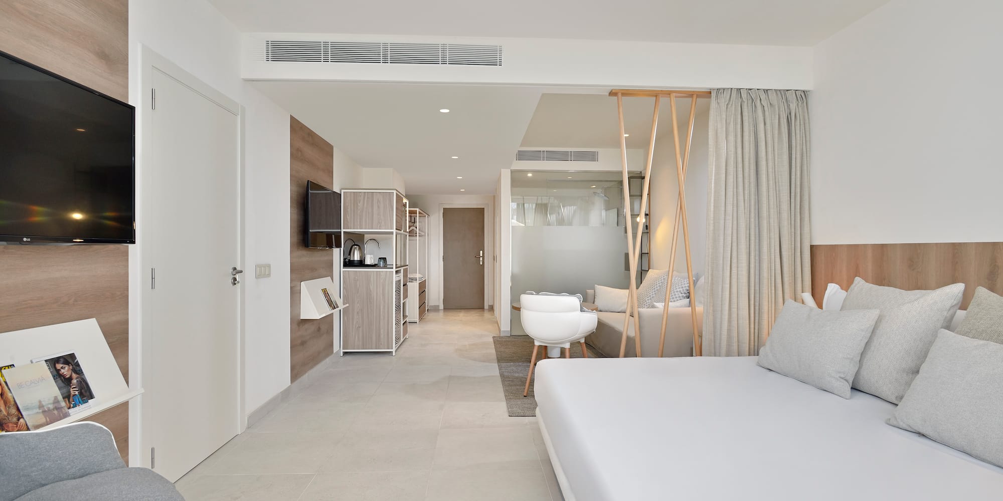 a room with a bed and a television