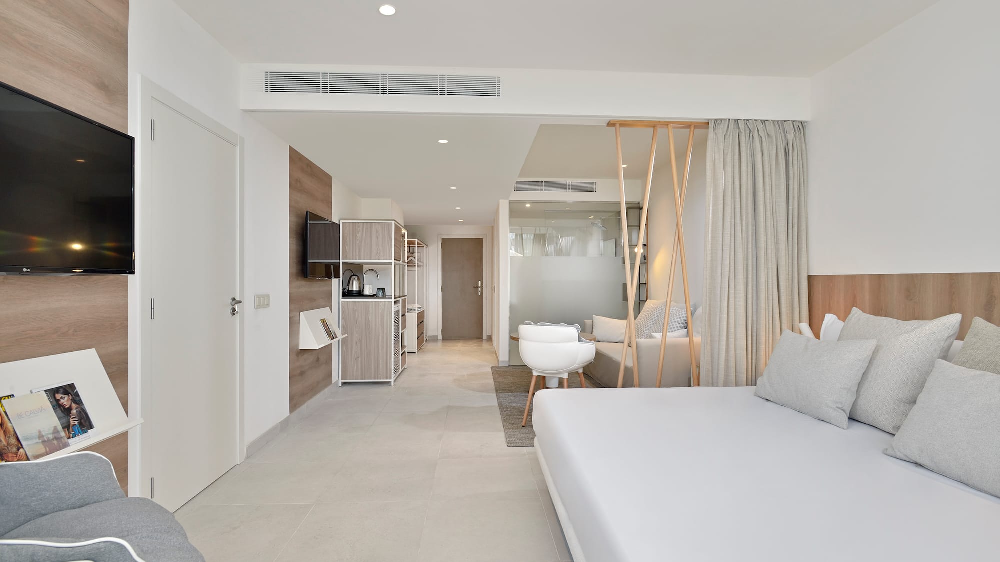 a room with a bed and a television