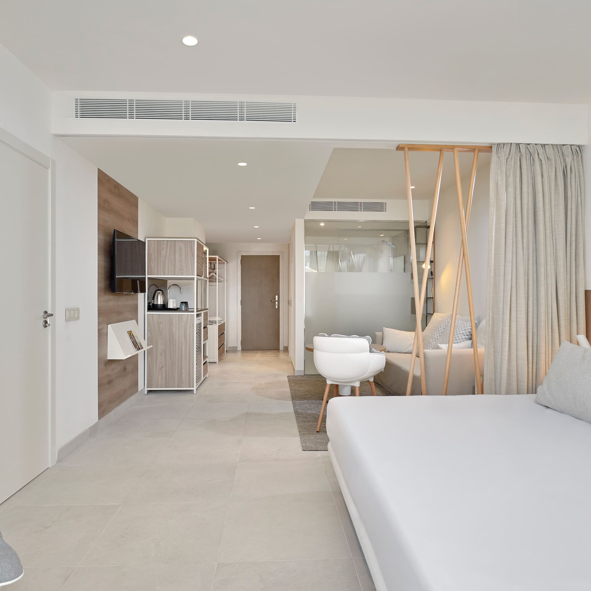 a room with a bed and a television