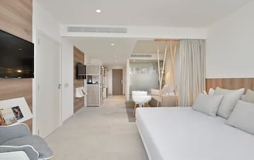 a room with a bed and a television