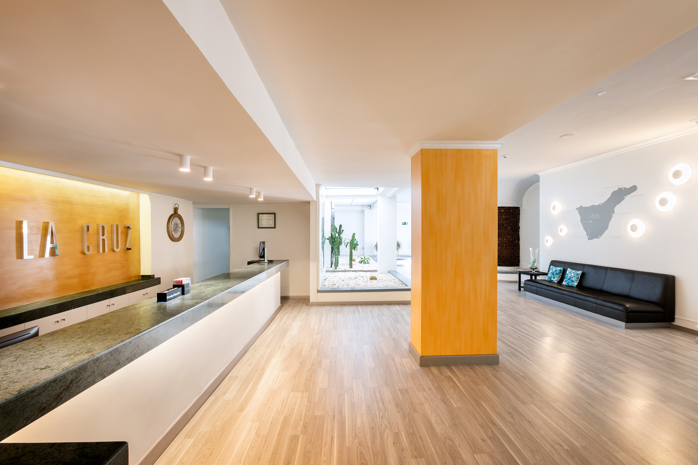 a lobby with a large stone column and a bench