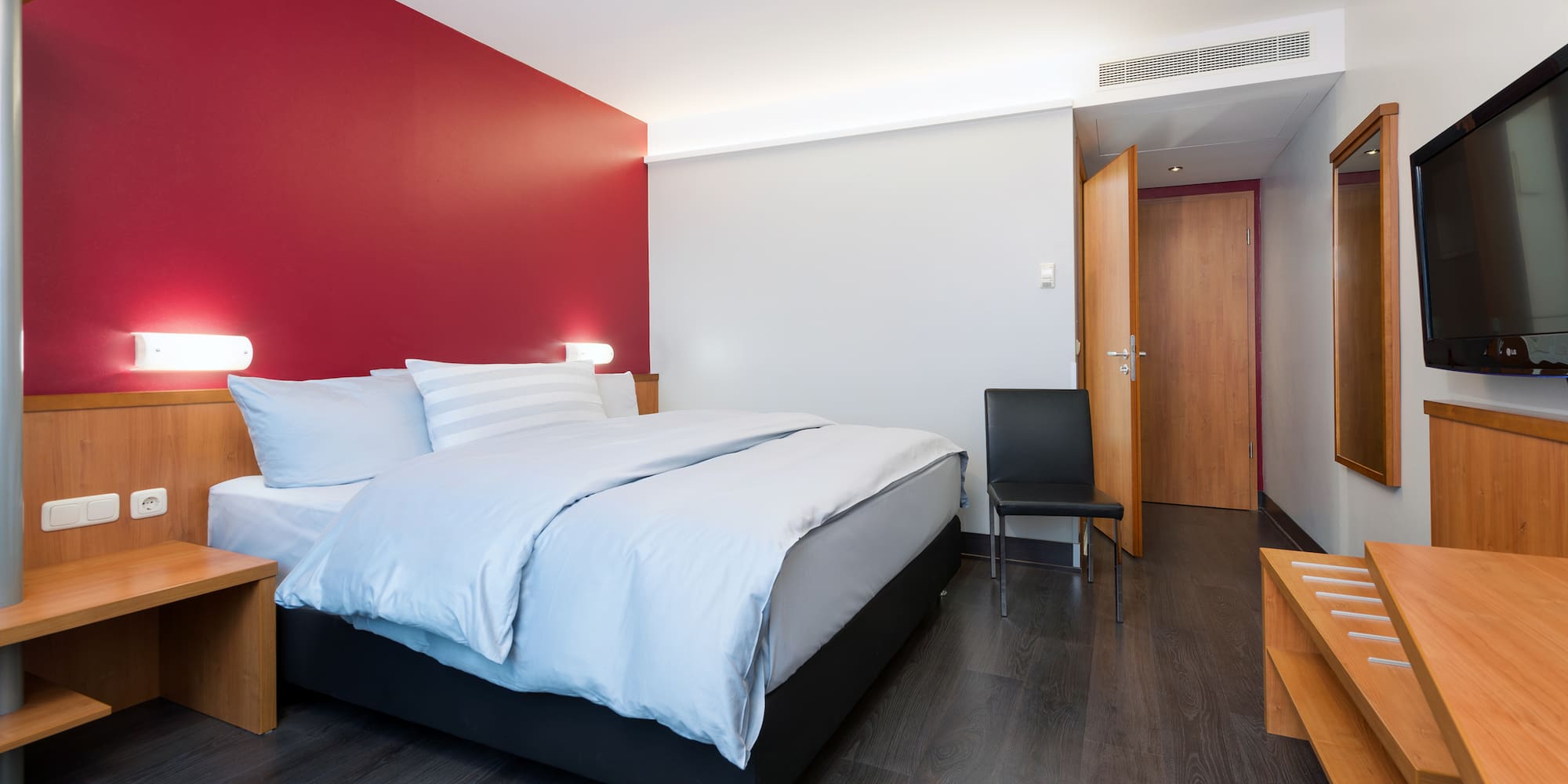 a bedroom with a bed and a chair