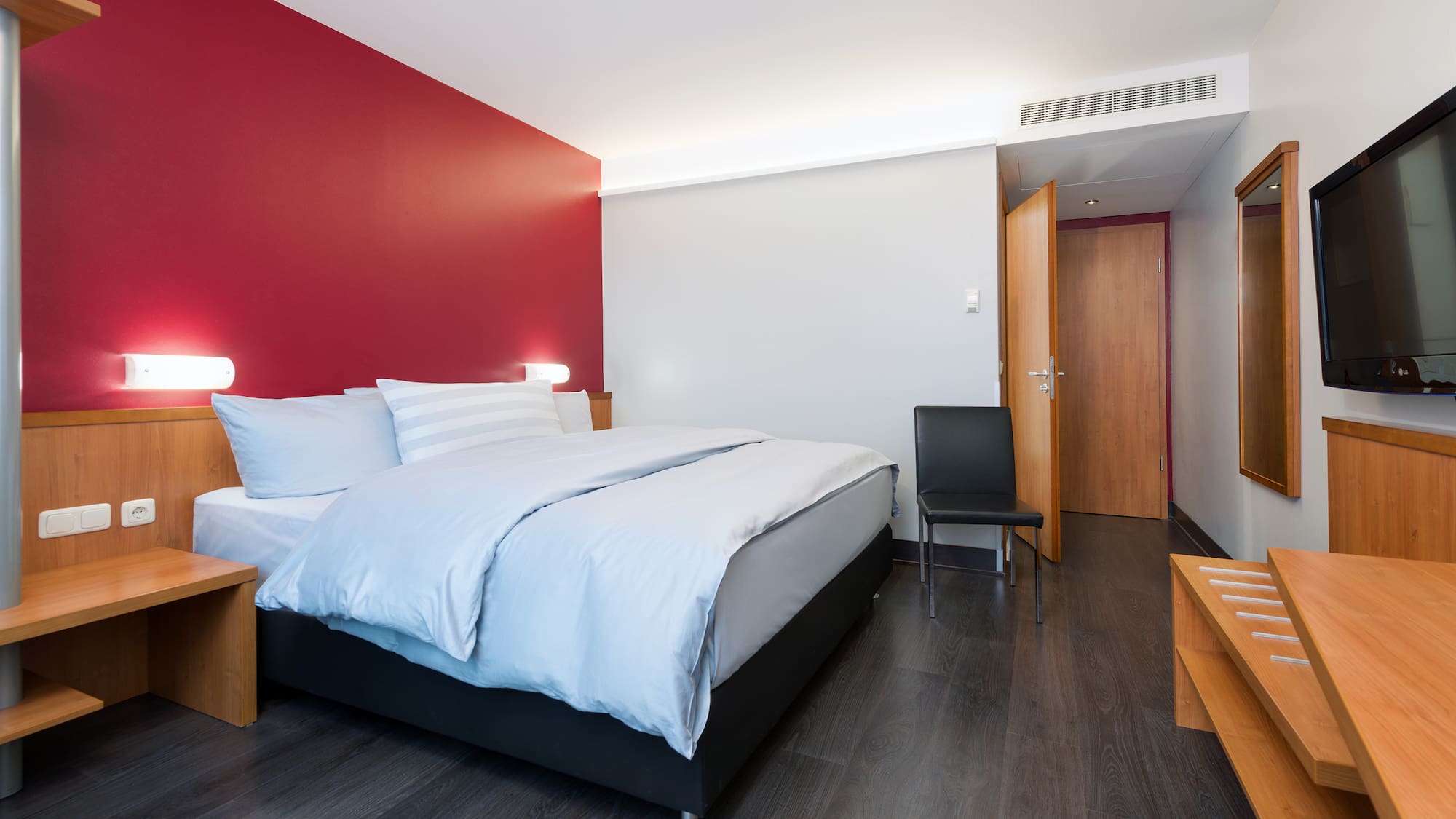 a bedroom with a bed and a chair