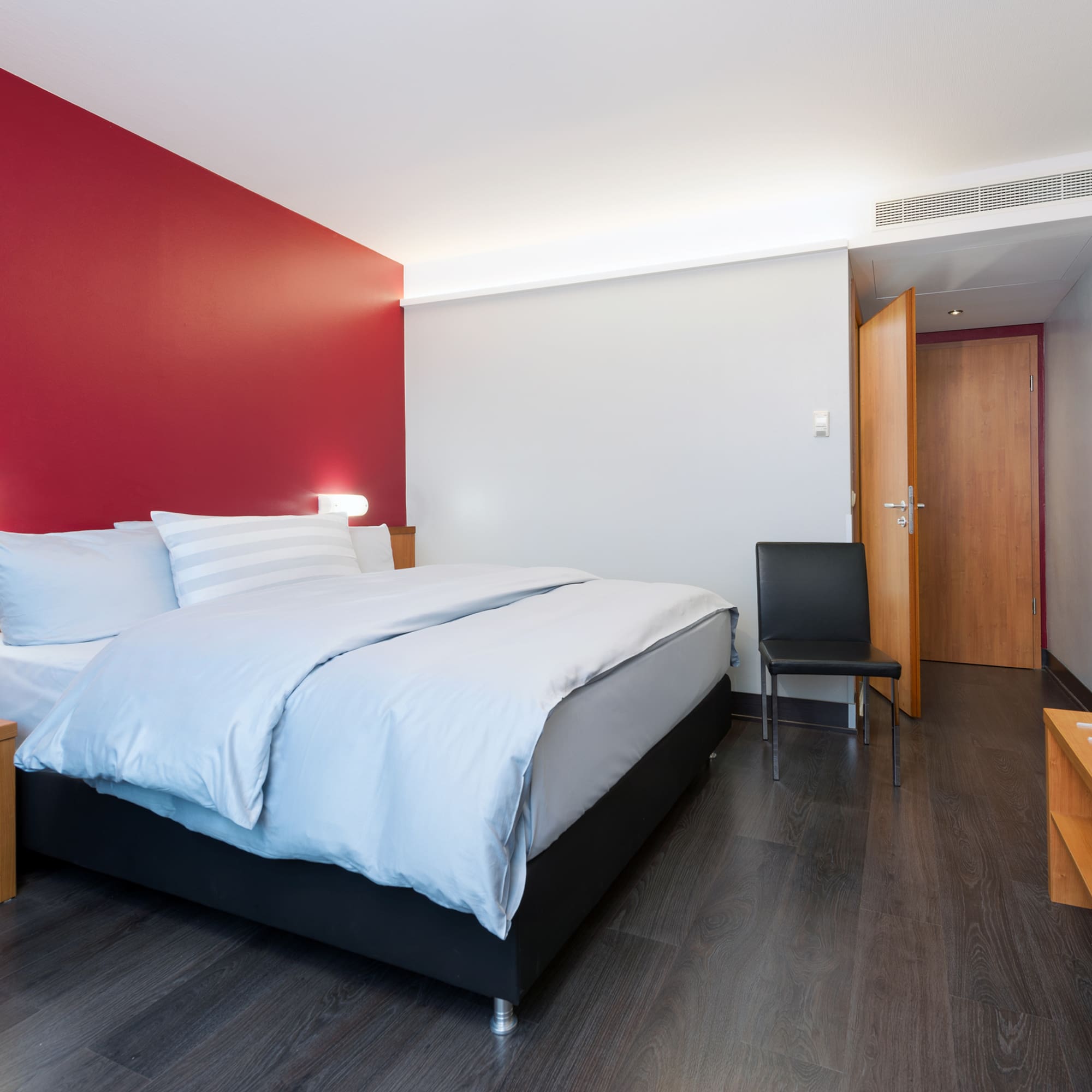 a bedroom with a bed and a chair