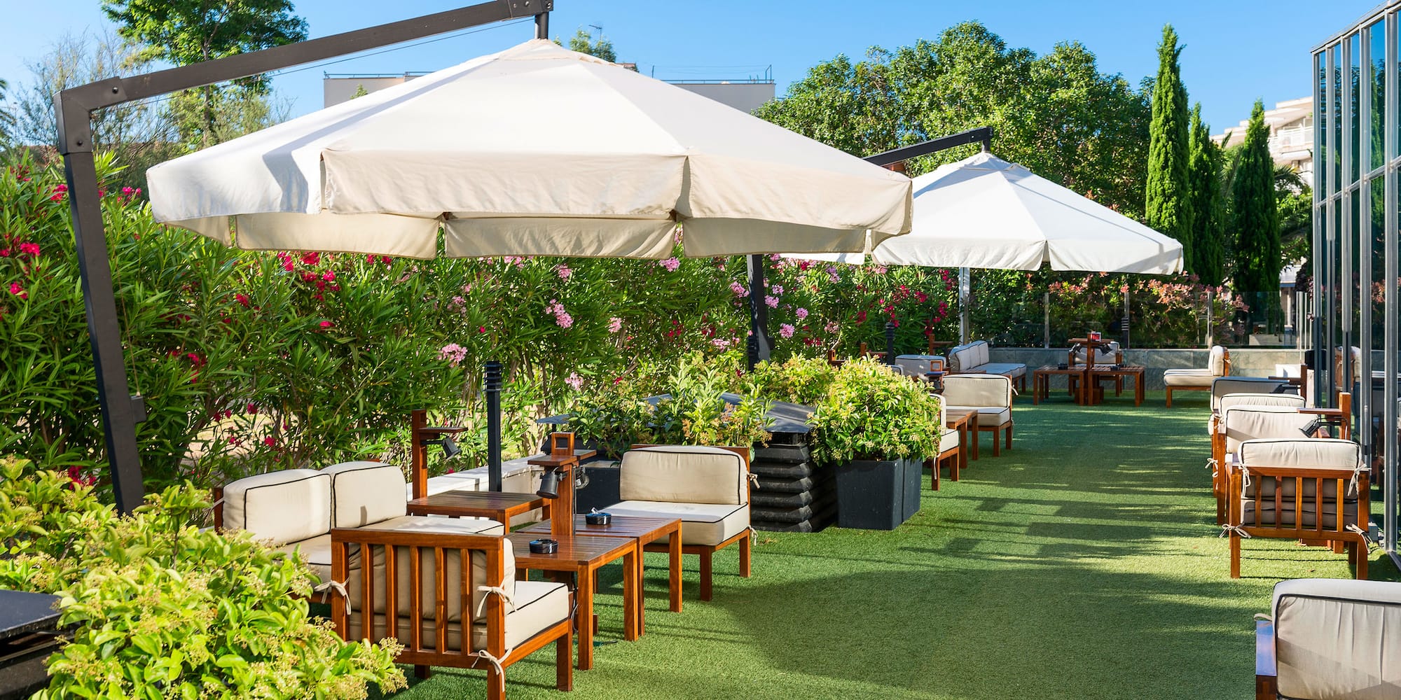 a patio area with chairs and umbrellas